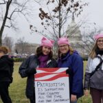 Womens March participants with patriotic sign in front of the U.S. Capital