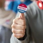 person holding an I Voted sticker