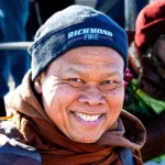A venerable Buddhist monk waves crossing the Manchester Bridge into Richmond, VA.